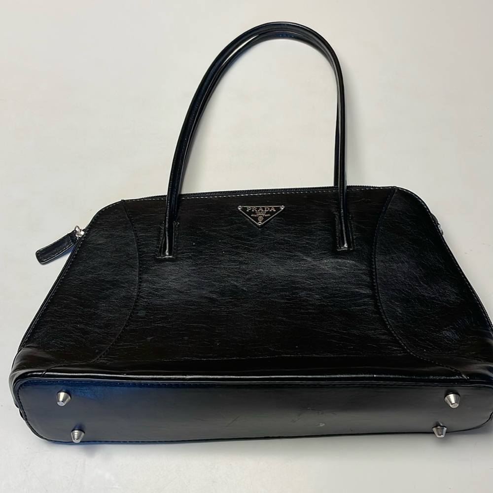 Dressy black bag with two handles.